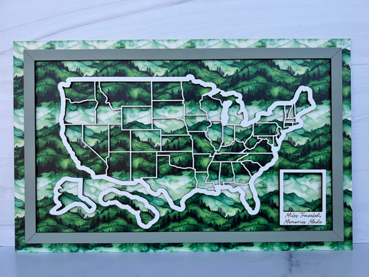 Framed map of the United States with a green mountainous watercolor background