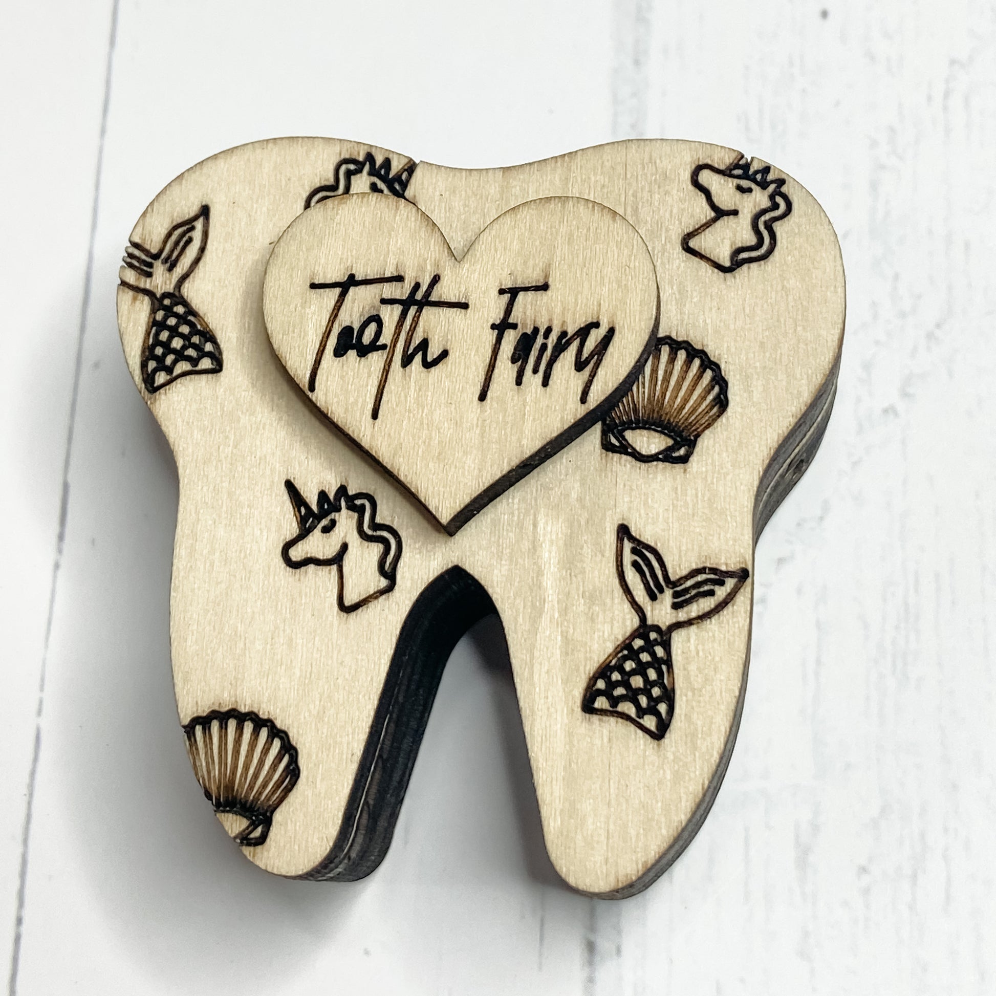 Mermaids & Unicorns design has engraved mermaid tails and Unicorn heads and Scallop shells. Tooth Fairy wording is in a whimsical font. 